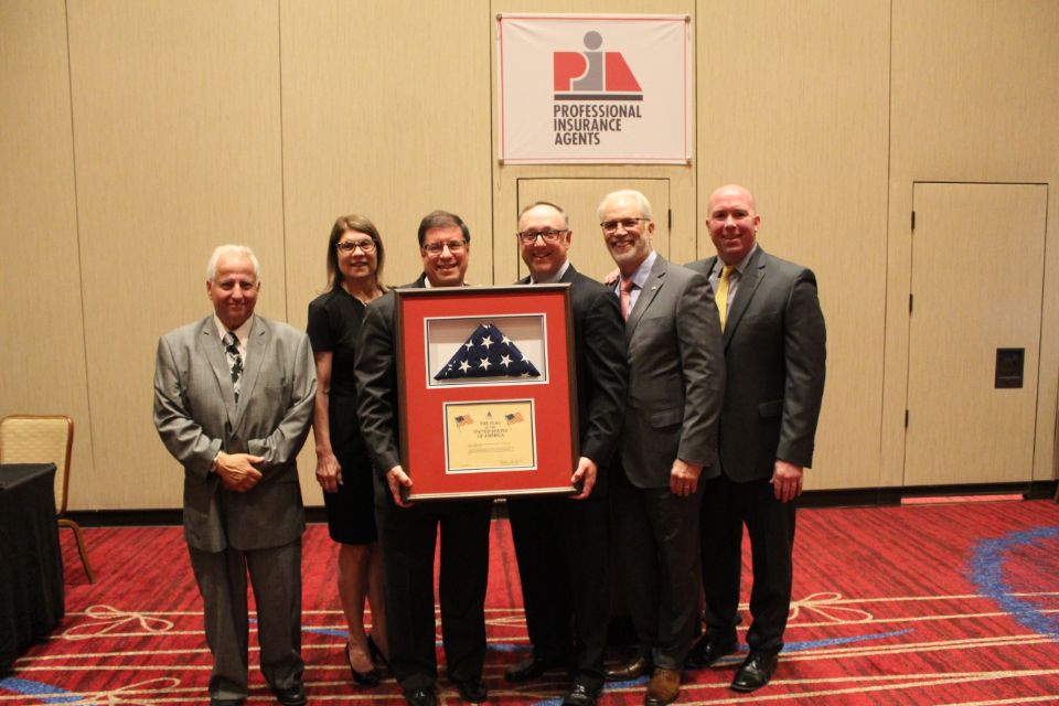 Newly elected President Bruce Blum, CPIA, along with PIANJ officers, presented outgoing President Lloyd “Rip” Bush, CPIA, with a flag that was flown over the U.S. Capitol.